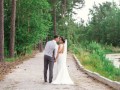 bride and groom walking by  the lake