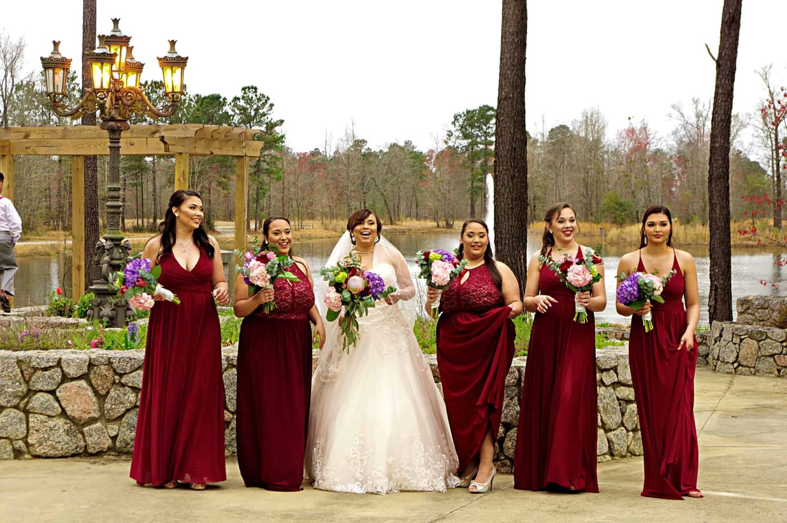 A group of women in red dresses standing next to each other.